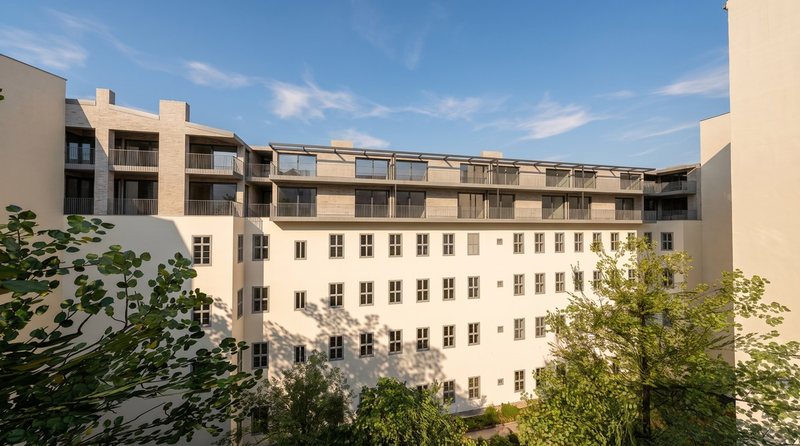 The inner courtyard, with its renovated façade and mature trees